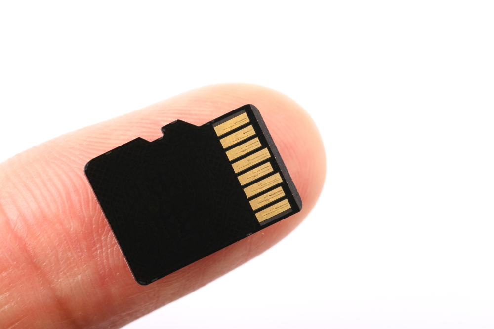 bigstock-Micro-Sd-Memory-Card-With-Fing-112809131
